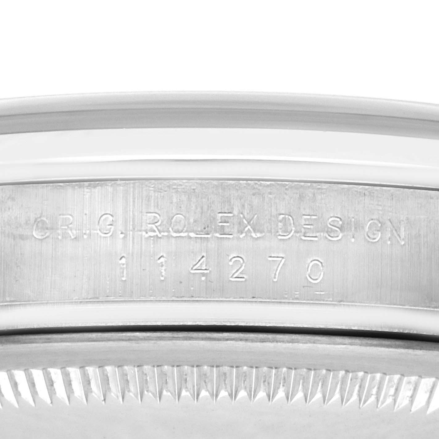 The image shows the side engraving of a Rolex Explorer 114270 Men
s Stainless Steel Black Dial 114270 Men
s Stainless Steel Black Dial model, focusing on the case reference number.