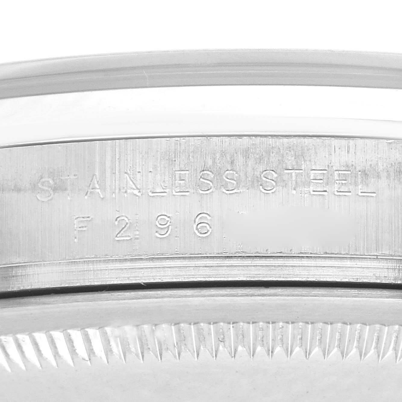 The image shows a close-up of the side of a Rolex Explorer 114270 Men
s Stainless Steel Black Dial 114270 Men
s Stainless Steel Black Dial watch, highlighting the stainless steel engraving and teeth of the bezel.