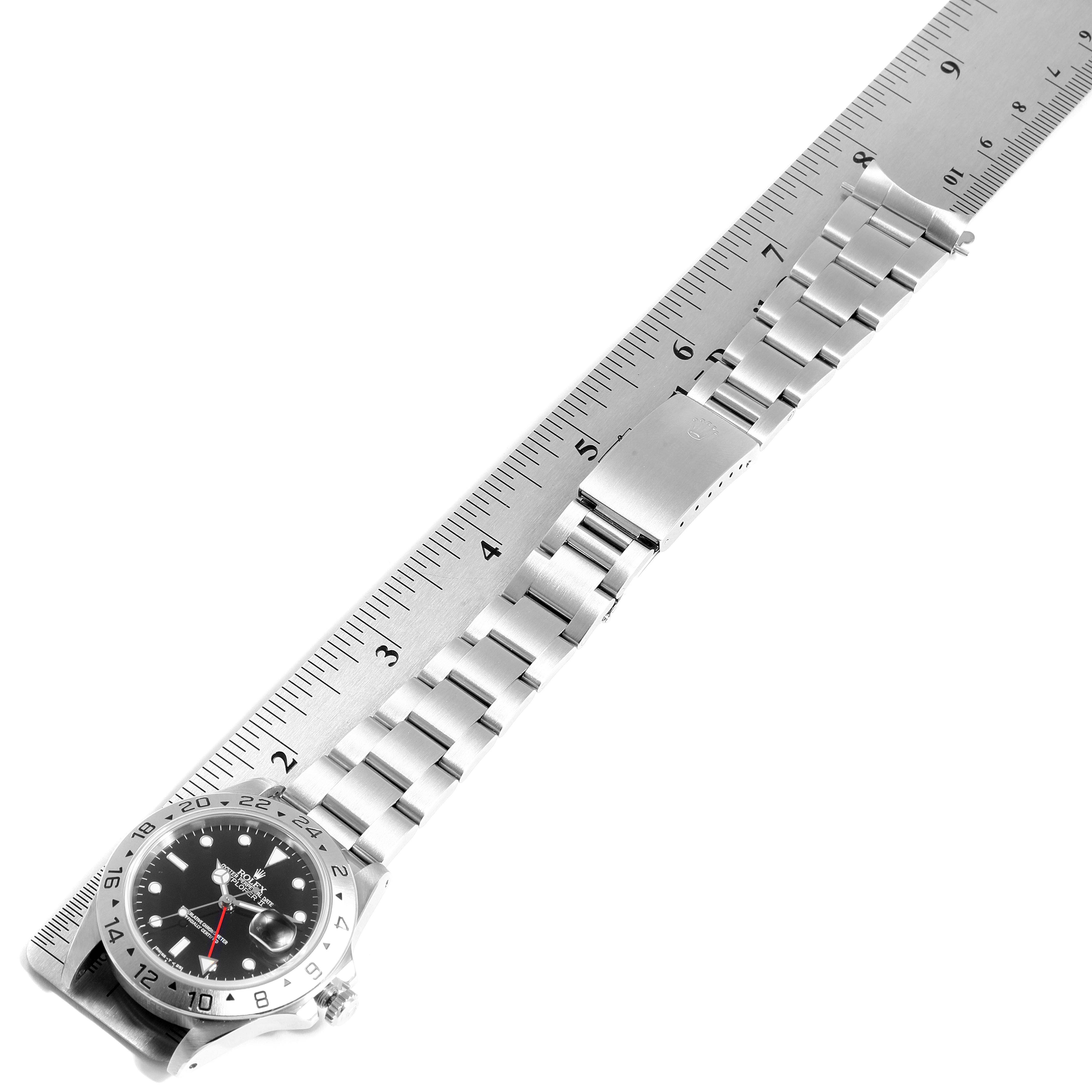 The image shows a Rolex Explorer 16570 Men
s Stainless Steel Black Dial 16570 Men
s Stainless Steel Black Dial watch laid flat next to a ruler, highlighting the watch case, dial, and metal bracelet.