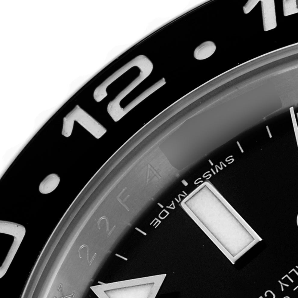 The image shows a close-up of the bezel and part of the dial of a Rolex GMT-Master 116710 Men's Stainless Steel Black Dial 116710 Men's Stainless Steel Black Dial watch, highlighting the numbers and markers.