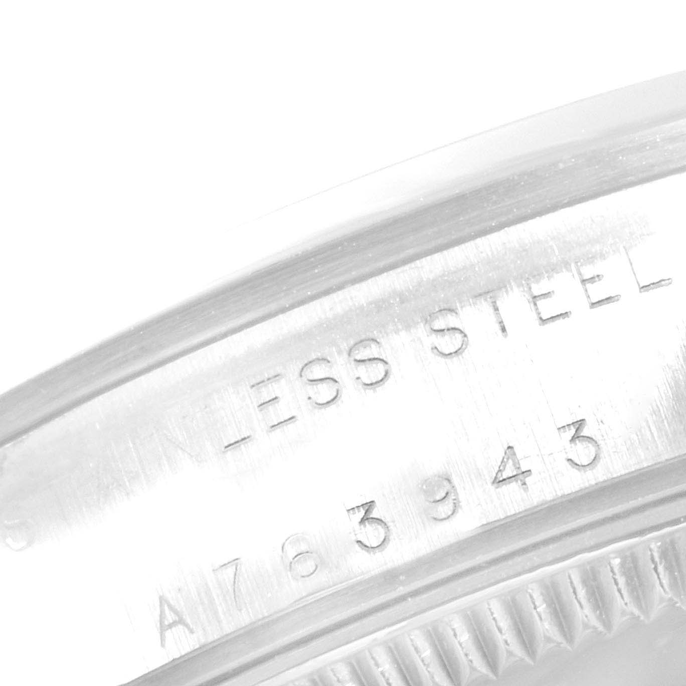 The image shows a close-up of the stainless steel casing and serial number engraving of a Rolex Mid-Size 77080 Women
s Stainless Steel Blue Dial 77080 Women
s Stainless Steel Blue Dial model watch.