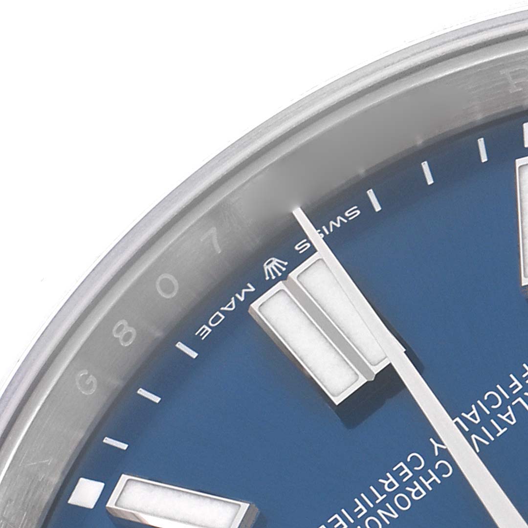 The image shows a close-up of the dial and bezel of a Rolex Oyster Perpetual 124300 Men
s Stainless Steel Blue Dial 124300 Men
s Stainless Steel Blue Dial watch, highlighting the blue dial and markers.