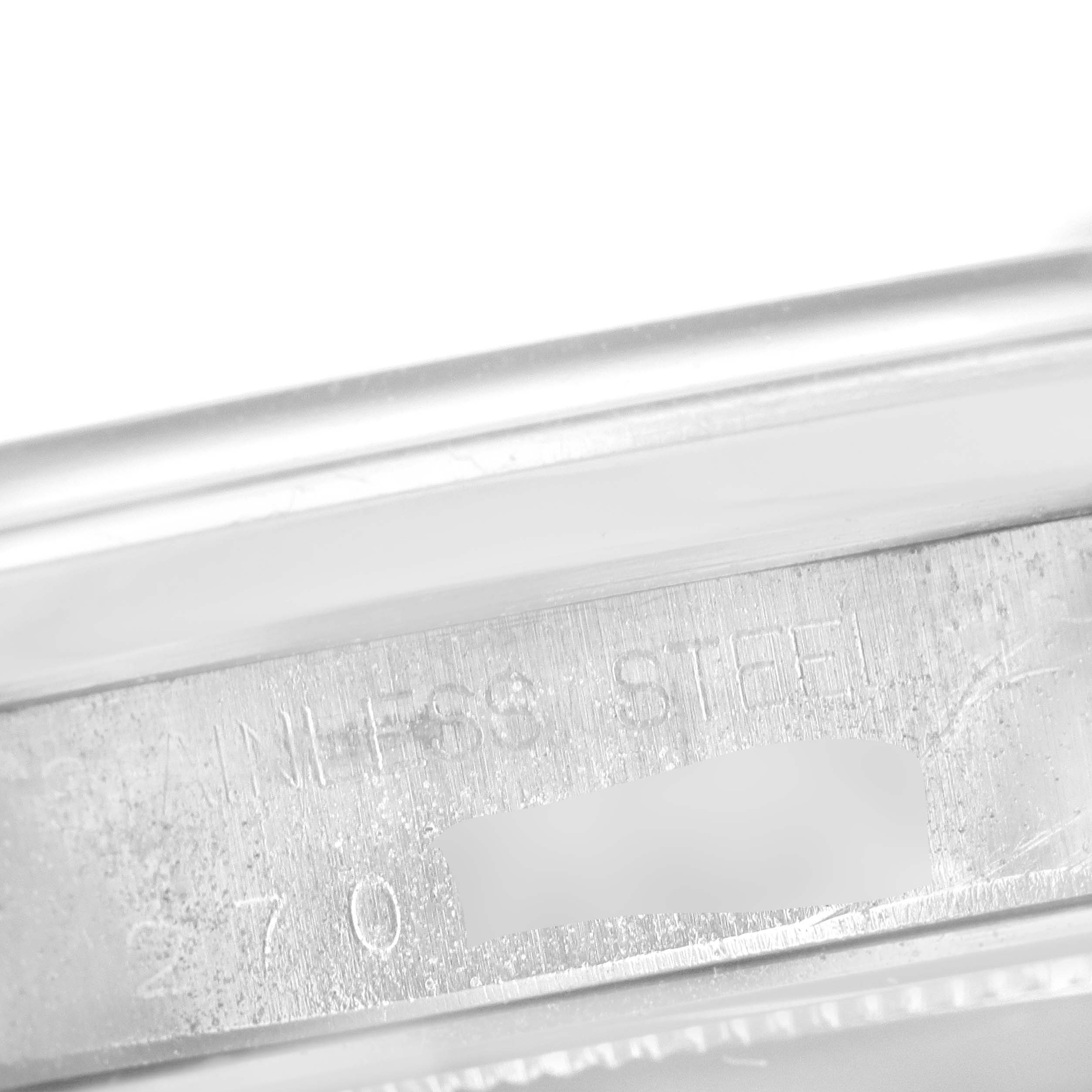 This close-up image shows the case side of a Rolex Vintage Collection 6694 Men
s Stainless Steel Silver Dial 6694 Men
s Stainless Steel Silver Dial watch, highlighting the stainless steel engraving and part of the serial number.