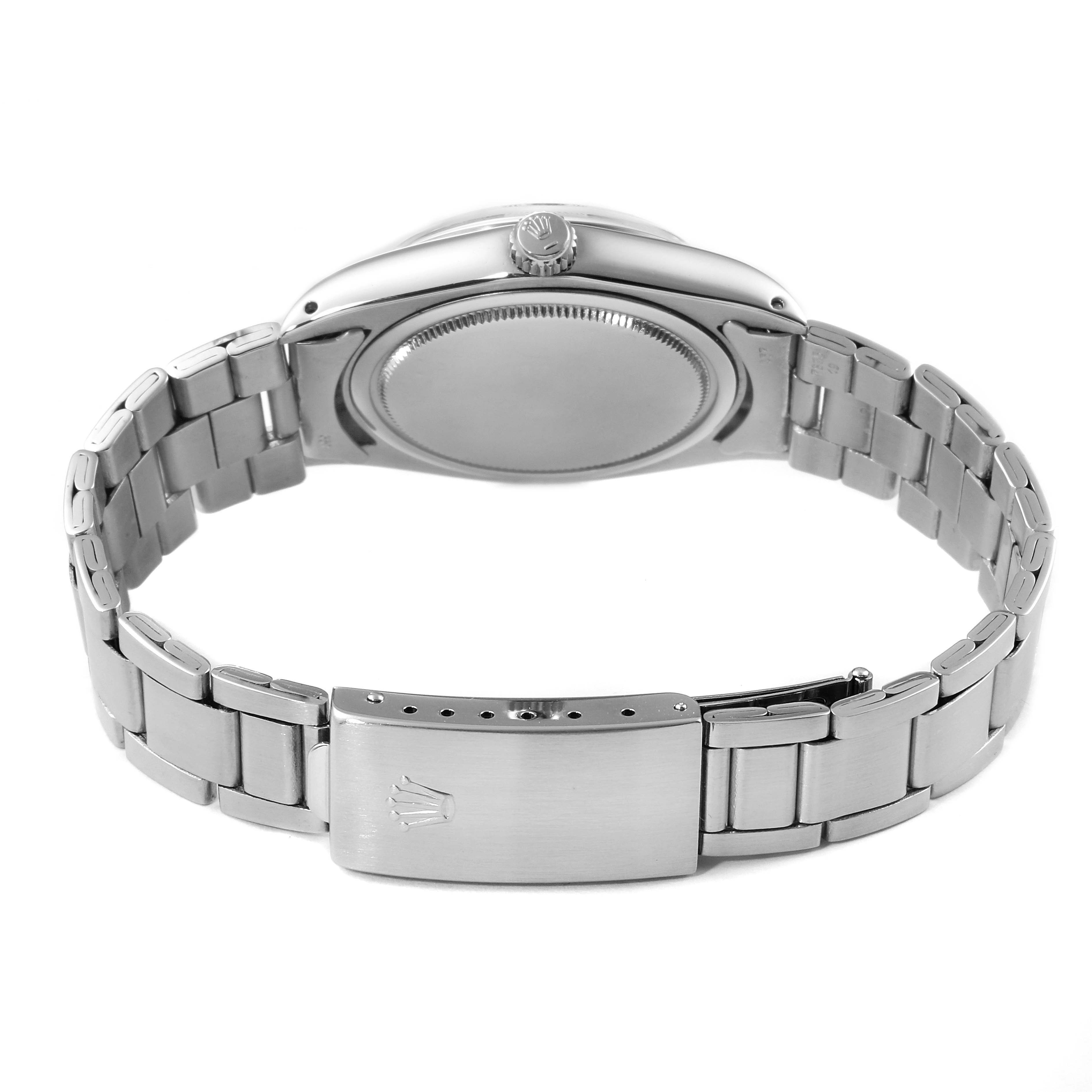 The image shows a Rolex Vintage Collection 6694 Men
s Stainless Steel Silver Dial 6694 Men
s Stainless Steel Silver Dial watch from the back, highlighting its stainless steel case and bracelet.