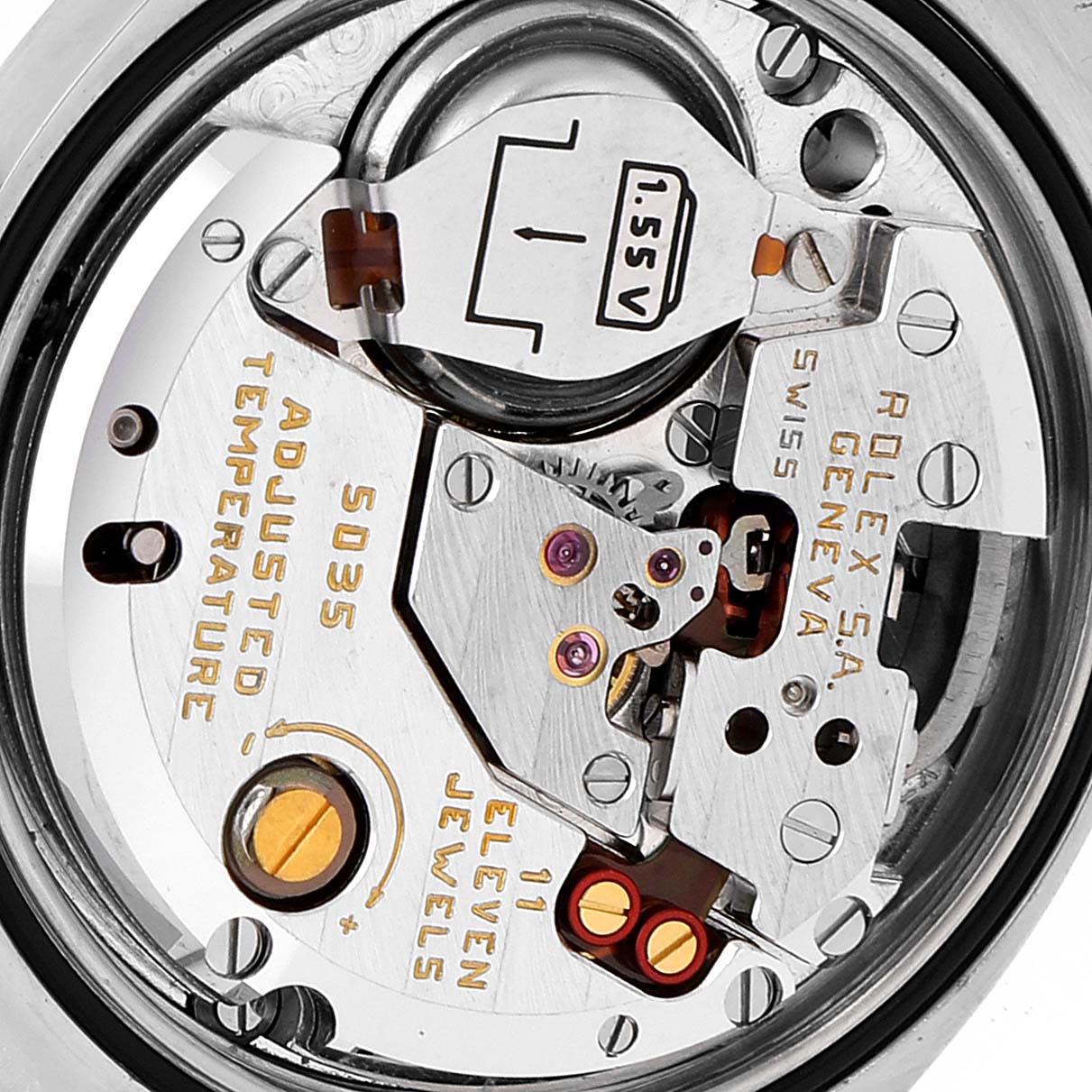 This is a close-up of the movement mechanism of a Rolex Oysterquartz 17013 Men's Steel and Gold (two tone) Blue Dial 17013 Men's Steel and Gold (two tone) Blue Dial watch, showcasing internal components and the battery.