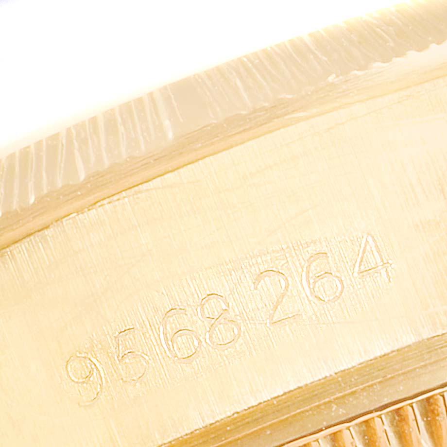 This close-up angle shows the engraved serial number on the side of the Rolex President 69278 Women
s Yellow Gold Champagne Dial 69278 Women
s Yellow Gold Champagne Dial watch case.