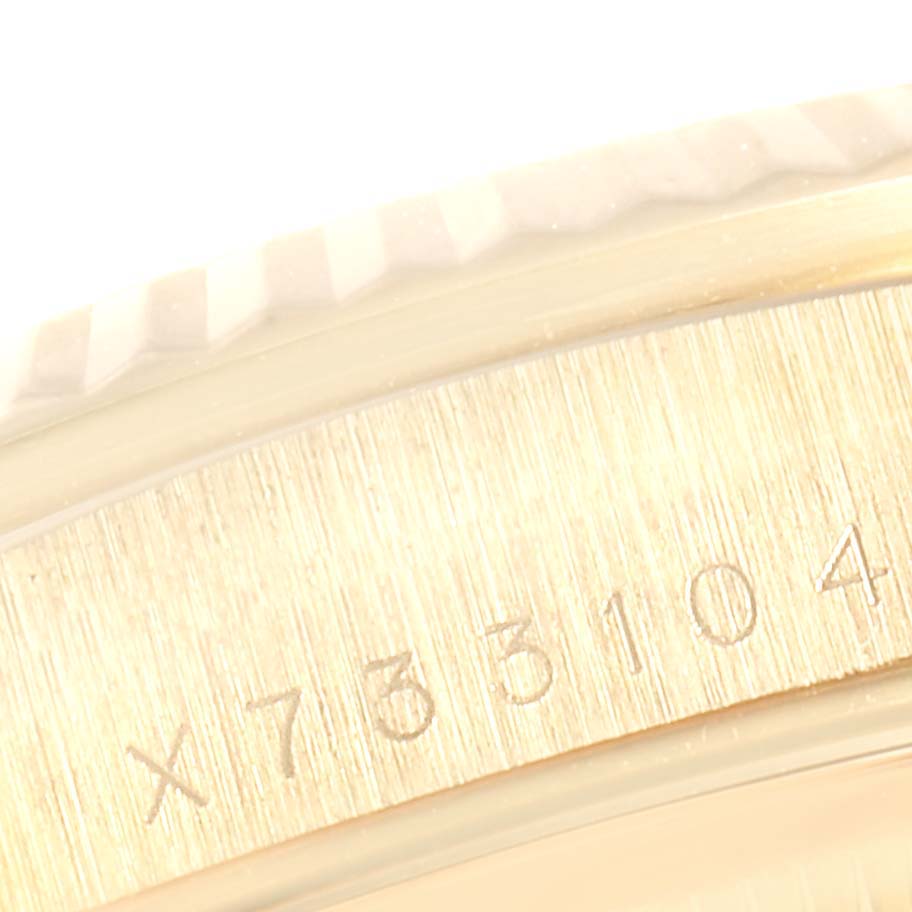 This close-up image of the Rolex President 18238 Men
s Yellow Gold Champagne Dial 18238 Men
s Yellow Gold Champagne Dial model shows the engraved serial number on its case.