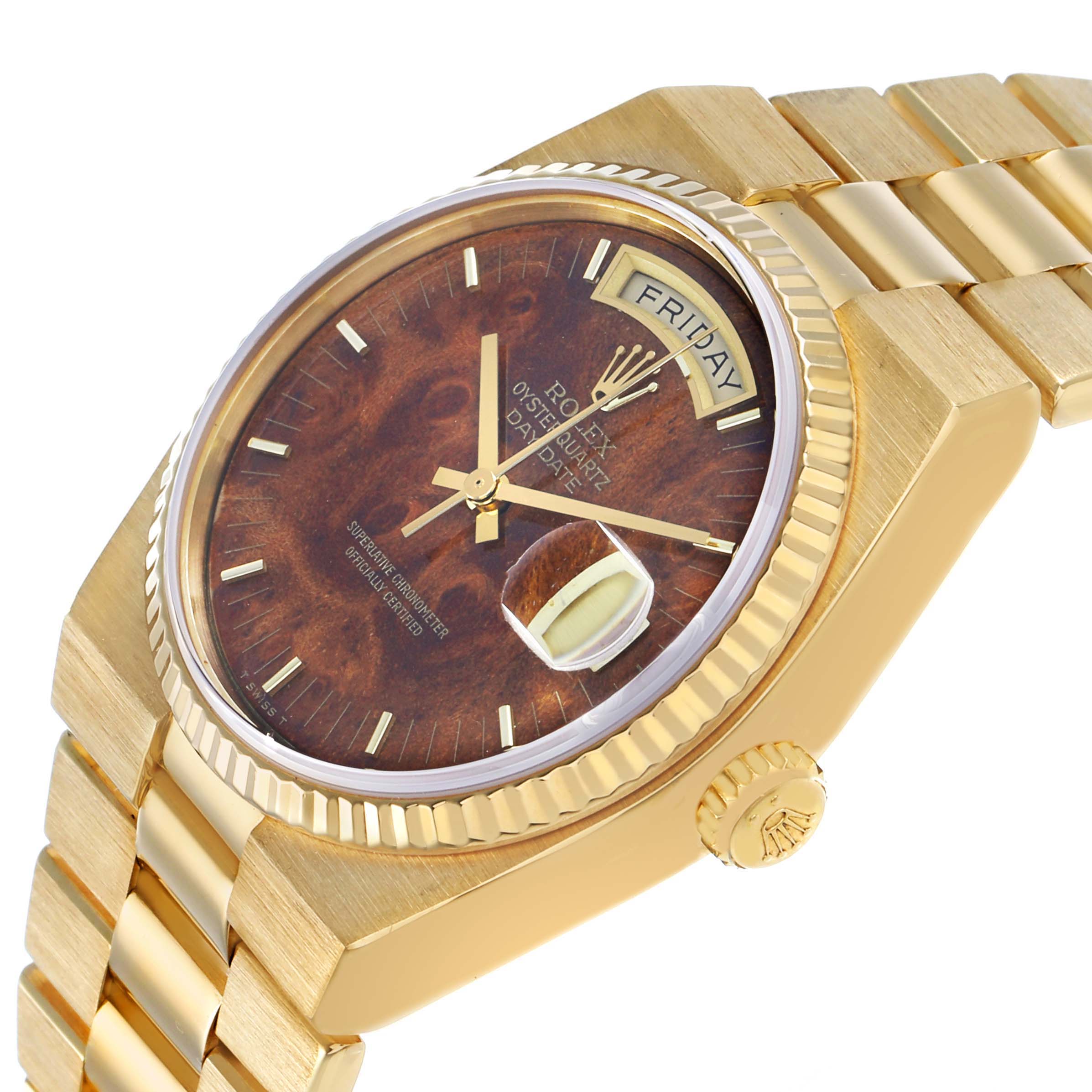 The Rolex Oysterquartz 19018 Men's Yellow Gold Brown Dial watch is shown at an angle displaying its textured dial, fluted bezel, and part of the bracelet.