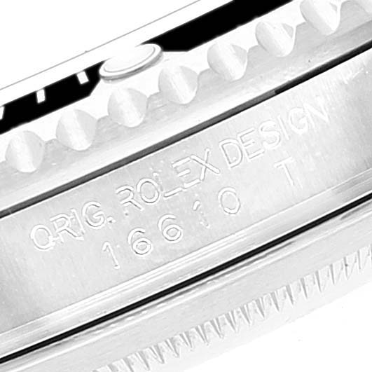 This image shows a close-up of the engraved bezel and case edge of a Rolex Submariner 16610 Men
s Stainless Steel Black Dial 16610 Men
s Stainless Steel Black Dial watch.