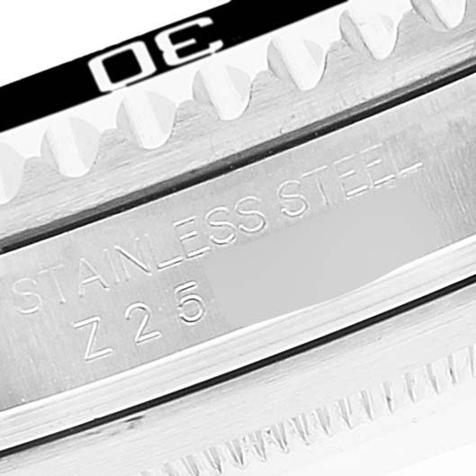 Close-up of the Rolex Submariner 16610 Men
s Stainless Steel Black Dial 16610 Men
s Stainless Steel Black Dial watch showing the bezel, teeth, and part of the case with "STAINLESS STEEL" inscribed.