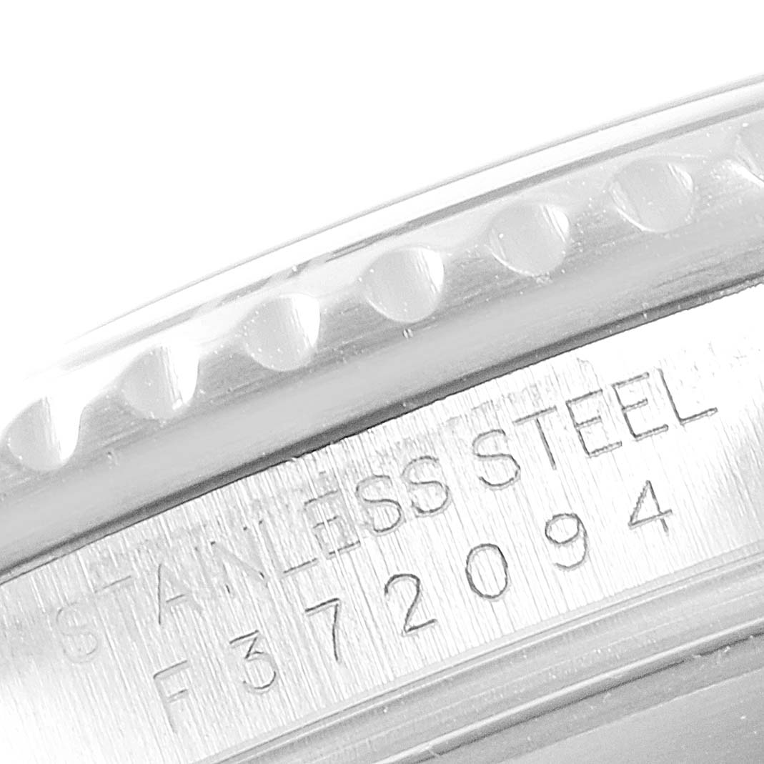The image shows a close-up of the engraved serial number section of a stainless steel Rolex Submariner 16610 Men
s Stainless Steel Black Dial 16610 Men
s Stainless Steel Black Dial watch.