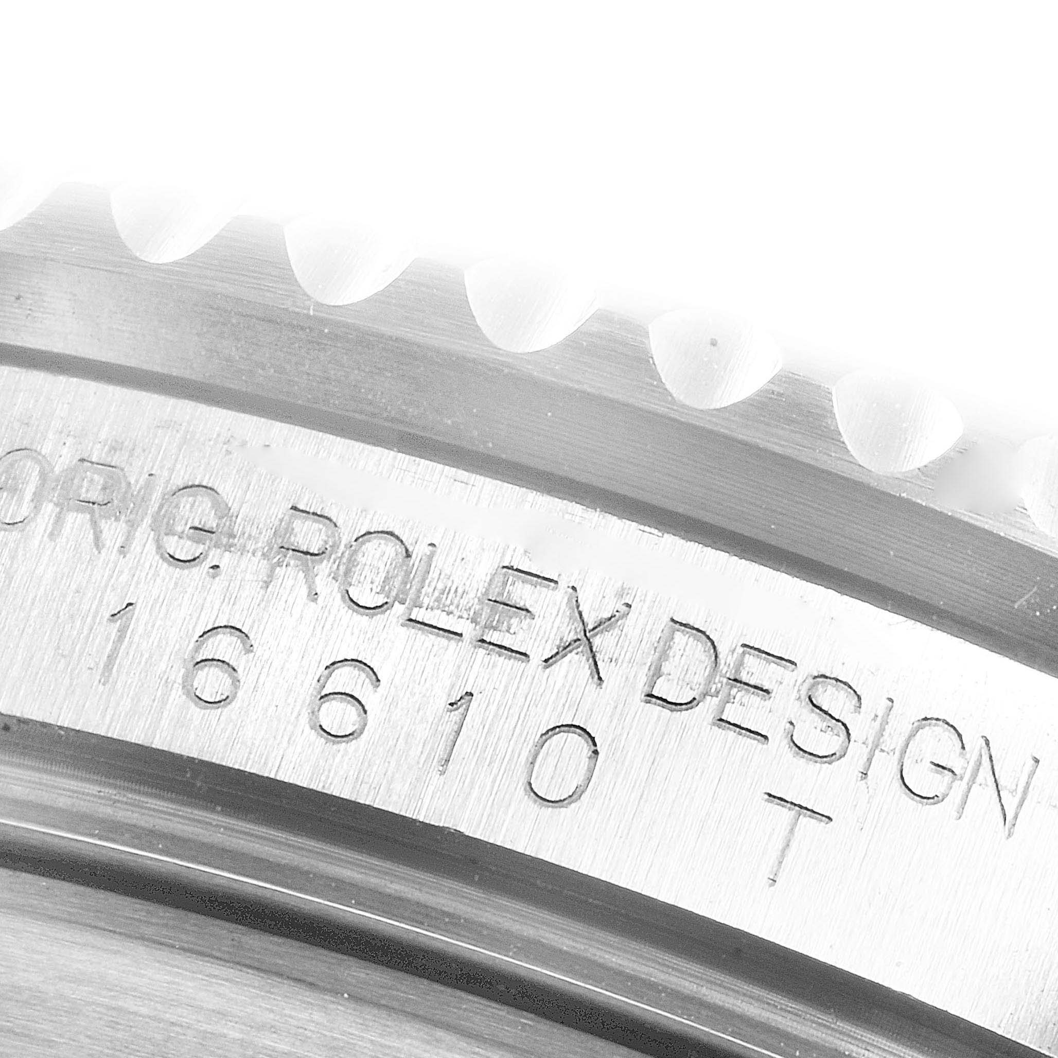 This close-up image shows the engraved case number and part of the bezel of a Rolex Submariner 16610 Men
s Stainless Steel Black Dial 16610 Men
s Stainless Steel Black Dial watch.