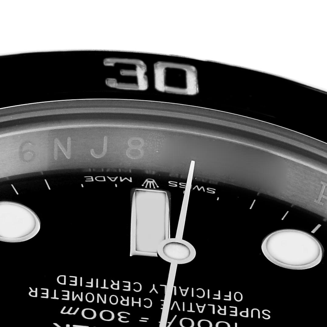 The image shows a close-up of a Rolex Submariner 124060 Men
s Stainless Steel Black Dial 124060 Men
s Stainless Steel Black Dial
s dial, with visible hands and partial text.