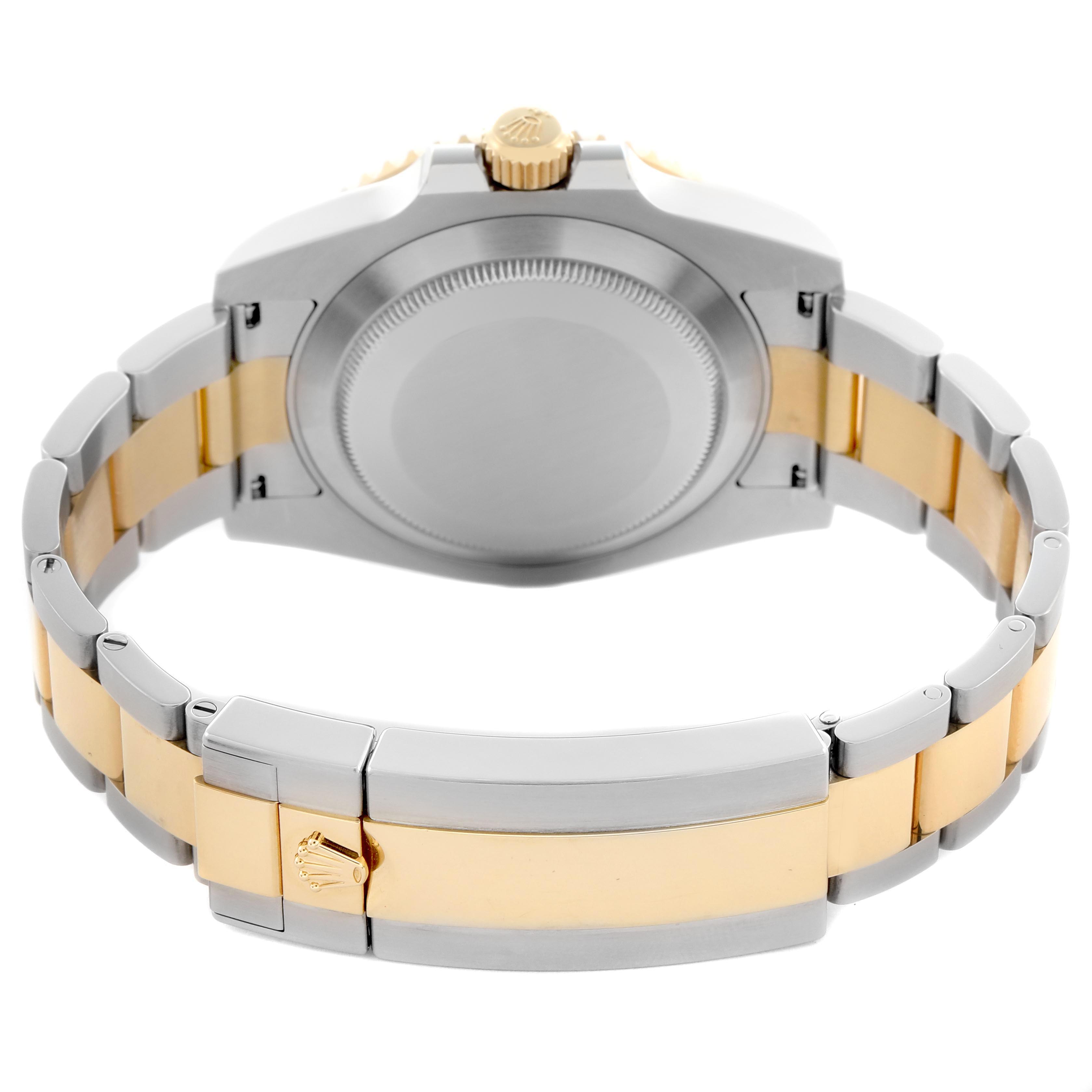 The Rolex Submariner 116613 Men
s Steel and Gold (two tone) Blue Dial 116613 Men
s Steel and Gold (two tone) Blue Dial is shown from the case back angle, displaying its two-tone bracelet and folding clasp.