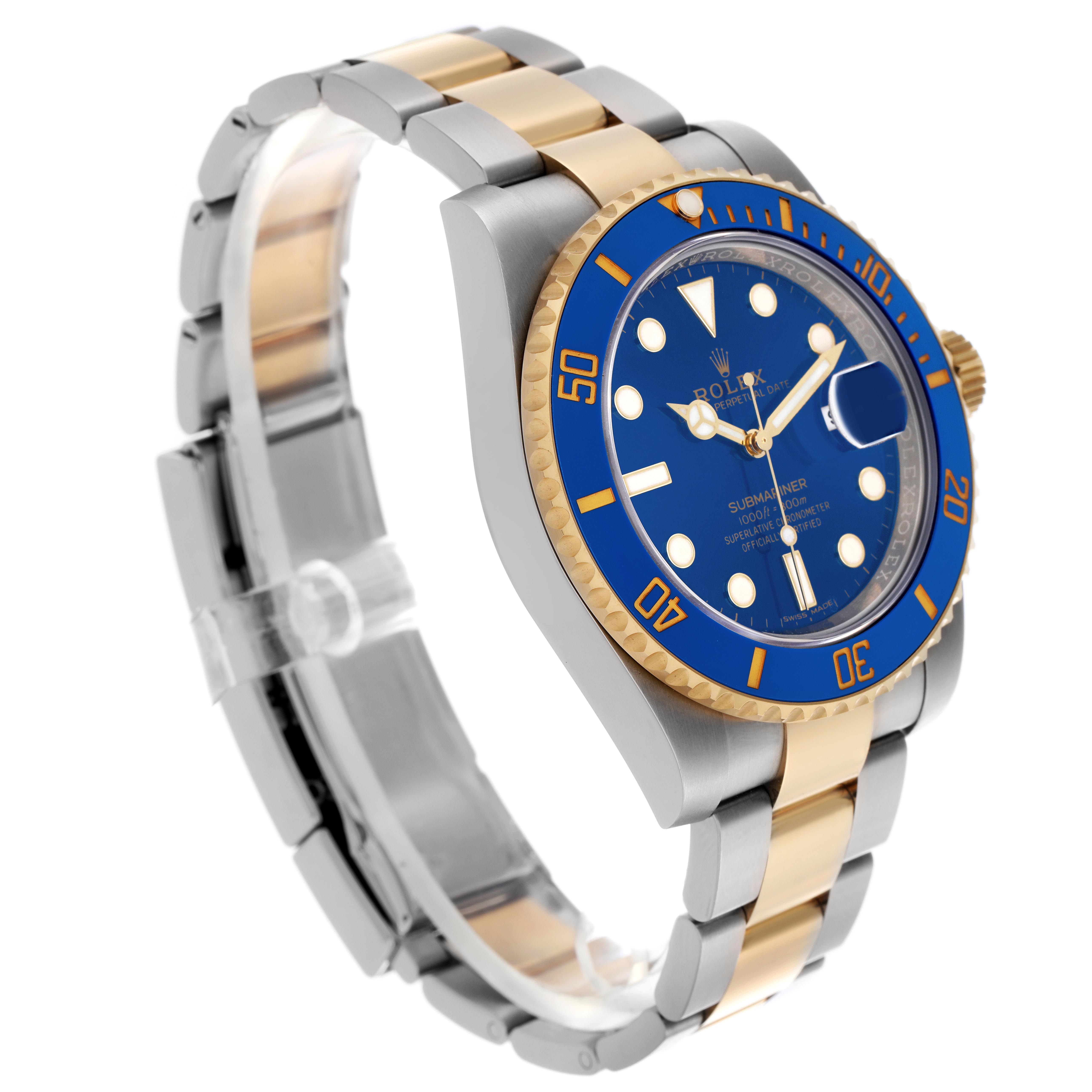 The image shows a Rolex Submariner 116613 Men
s Steel and Gold (two tone) Blue Dial 116613 Men
s Steel and Gold (two tone) Blue Dial from a three-quarter angle, highlighting its blue dial, bezel, and two-tone bracelet.