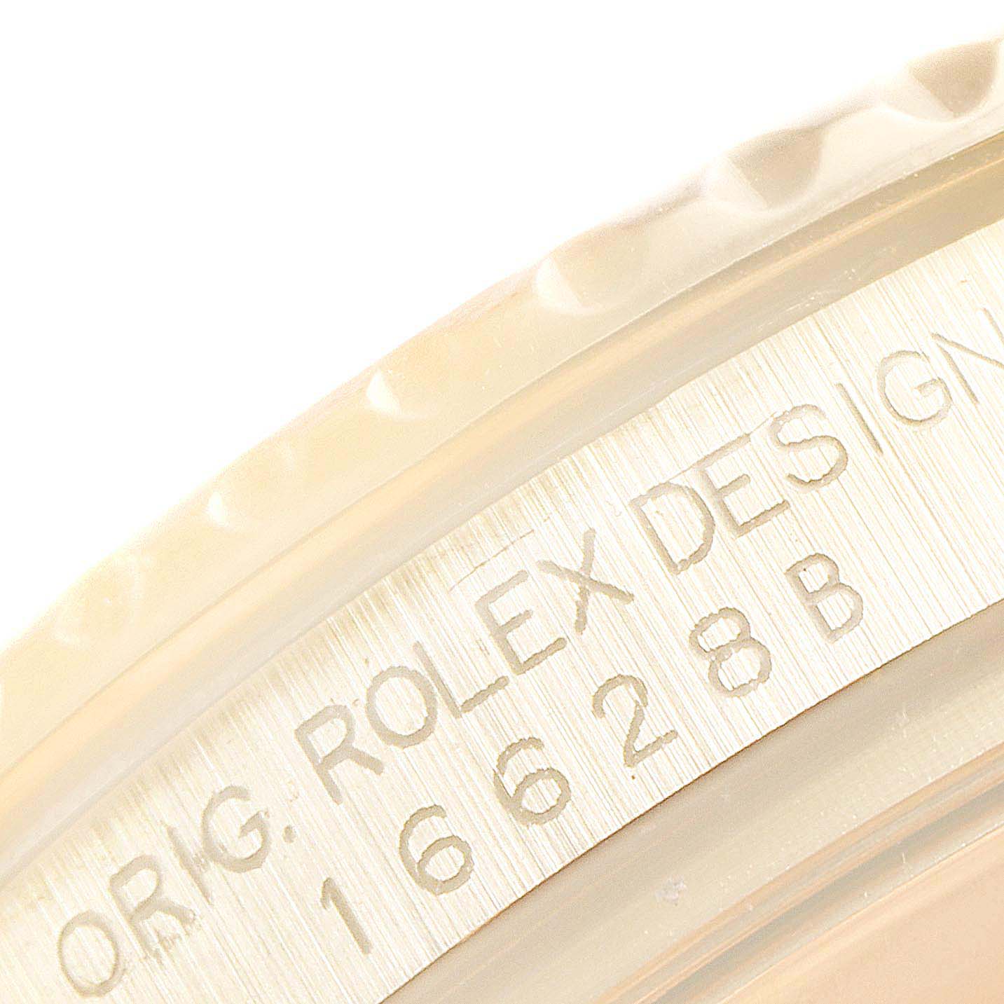 The image shows a close-up of the Rolex Yacht-Master 16628 Men
s Yellow Gold White Dial 16628 Men
s Yellow Gold White Dial
s bezel and case edge, displaying its engraved model number and design details.