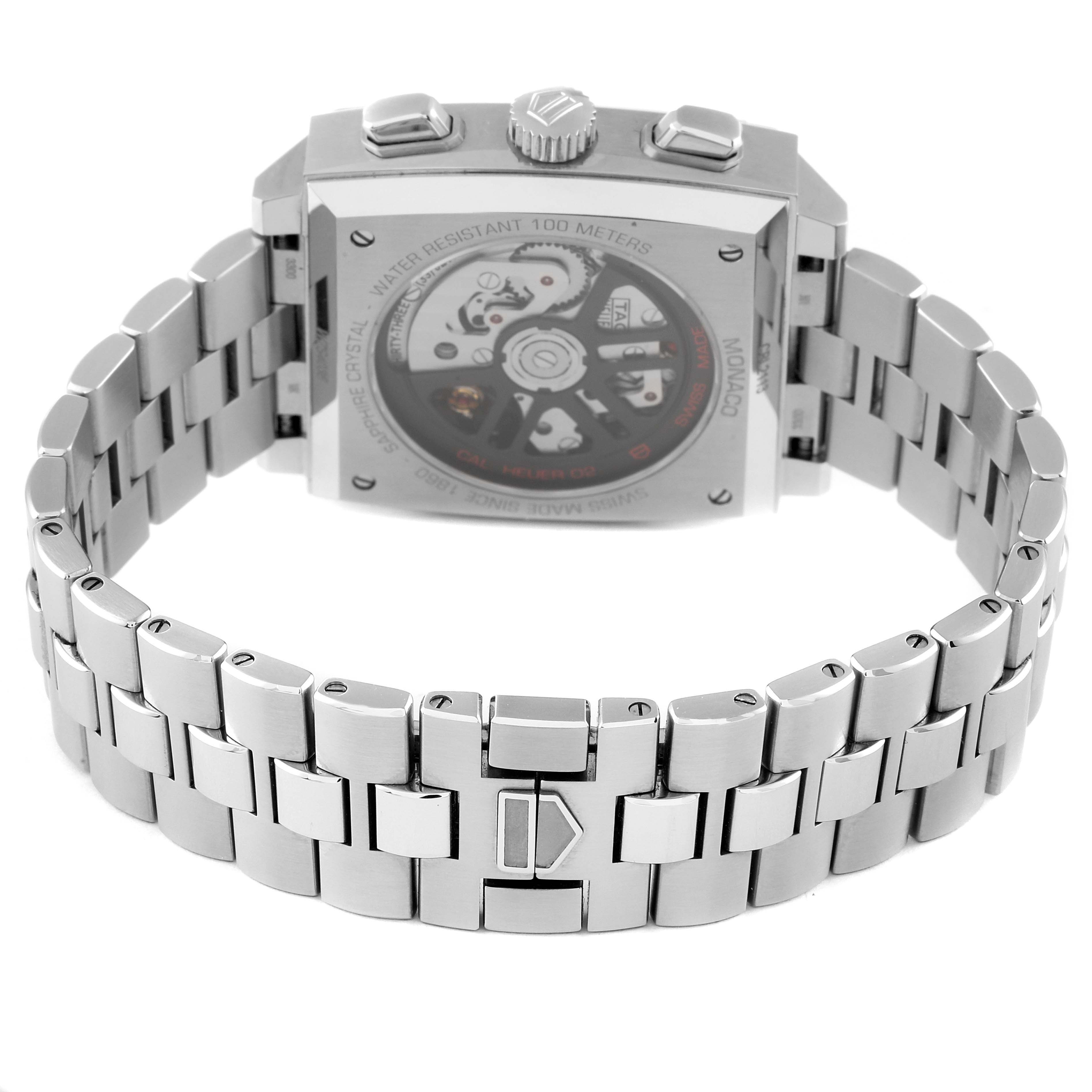 The image shows the back view of a Tag Heuer Monaco CBL2113 Men's Stainless Steel Black Dial CBL2113 Men's Stainless Steel Black Dial watch, featuring its case, crown, buttons, and metal bracelet.