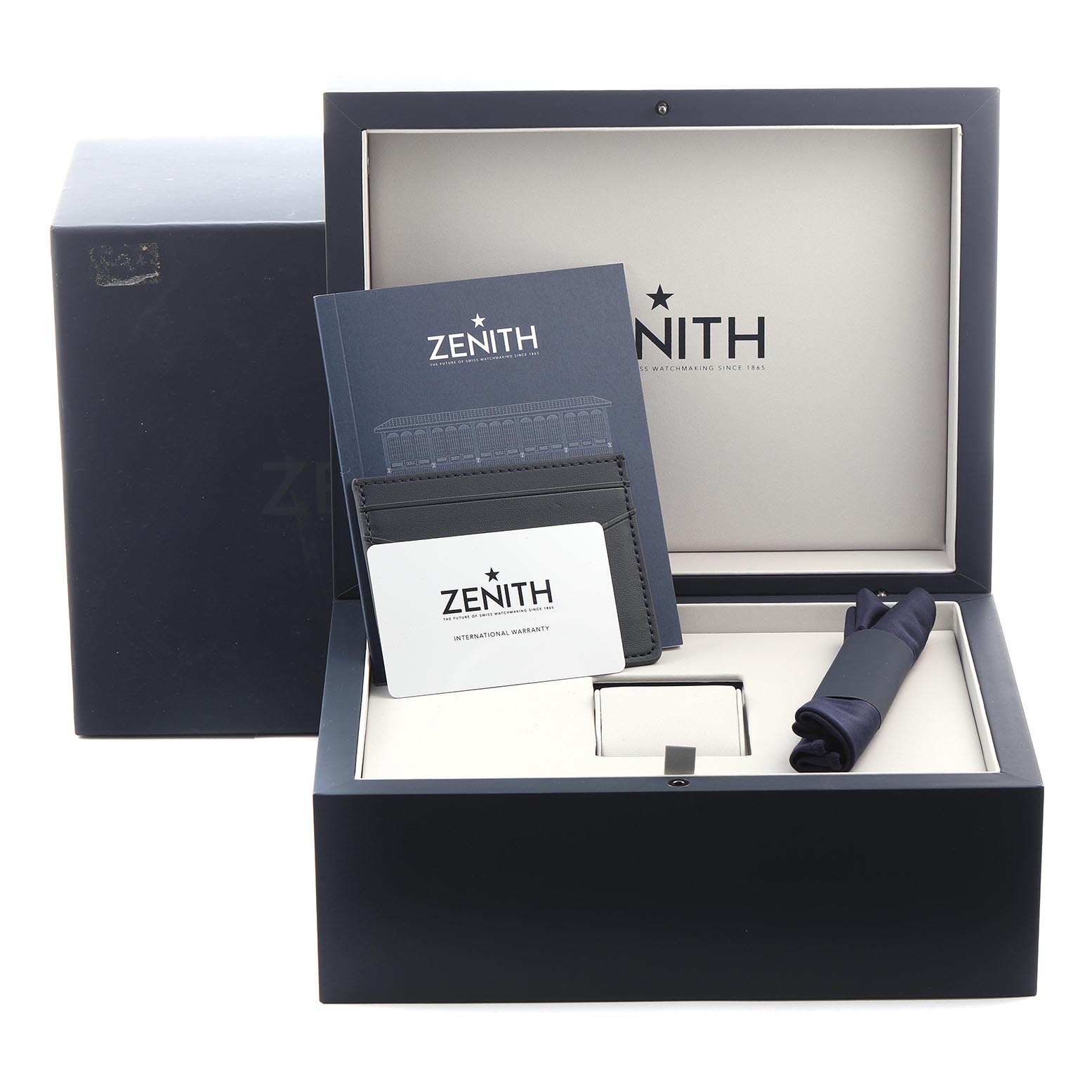 The image shows the Zenith Chronomaster 03.3107.3600/56.M3100 Men
s Stainless Steel Green Dial 03.3107.3600/56.M3100 Men
s Stainless Steel Green Dial watch box with branding, documentation, and accessories, viewed from the top.