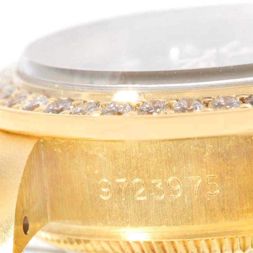 This close-up angle of the Rolex President 69178 Women's Yellow Gold Blue Dial 69178 Women's Yellow Gold Blue Dial model watch shows the side of the case, bezel with diamonds, and part of the crystal.
