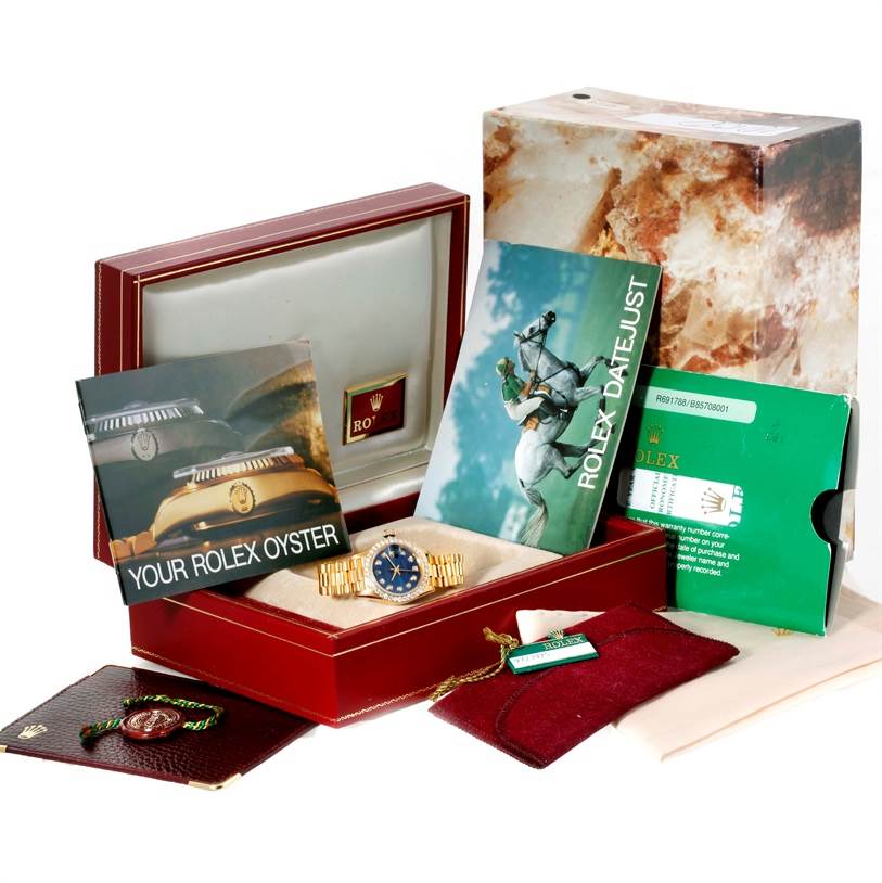 The image shows a Rolex President 69178 Women's Yellow Gold Blue Dial 69178 Women's Yellow Gold Blue Dial watch with its box, papers, and accessories.