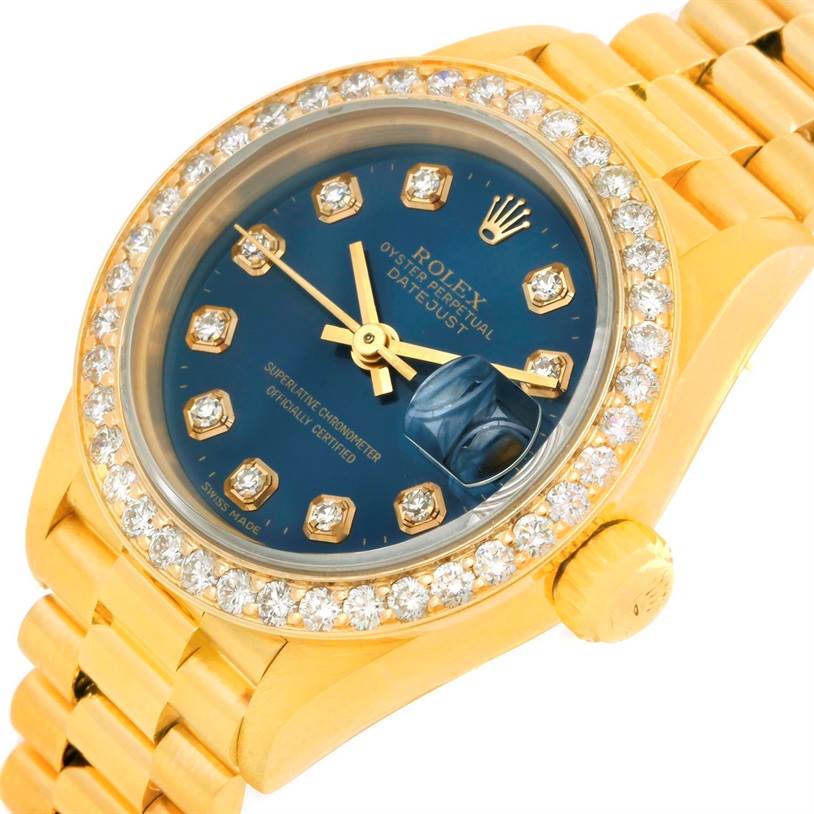 This image shows a close-up angle of the Rolex President 69178 Women's Yellow Gold Blue Dial 69178 Women's Yellow Gold Blue Dial model watch, highlighting its jeweled bezel, blue dial, and part of the bracelet.