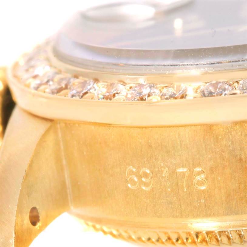 The image shows a close-up of a Rolex President 69178 Women's Yellow Gold Blue Dial 69178 Women's Yellow Gold Blue Dial model, focusing on the gold case, diamond bezel, and part of the serial number 69178.