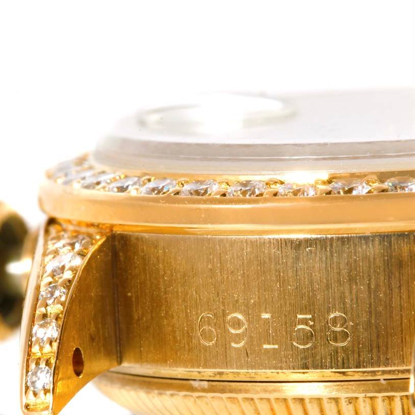 The image shows a close-up angle of the Rolex President 69158 Women's Yellow Gold Champagne Dial 69158 Women's Yellow Gold Champagne Dial watch's gold case, bezel with diamonds, and model number 69158.
