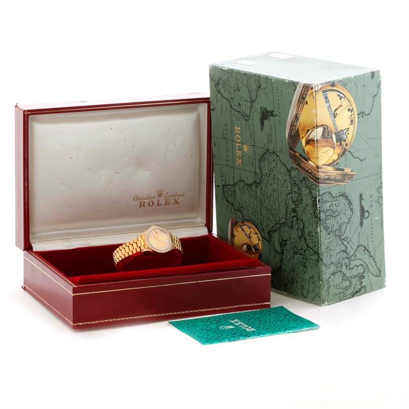 The image shows a Rolex President 69158 Women's Yellow Gold Champagne Dial 69158 Women's Yellow Gold Champagne Dial model watch in an open box, with additional packaging and a booklet nearby.