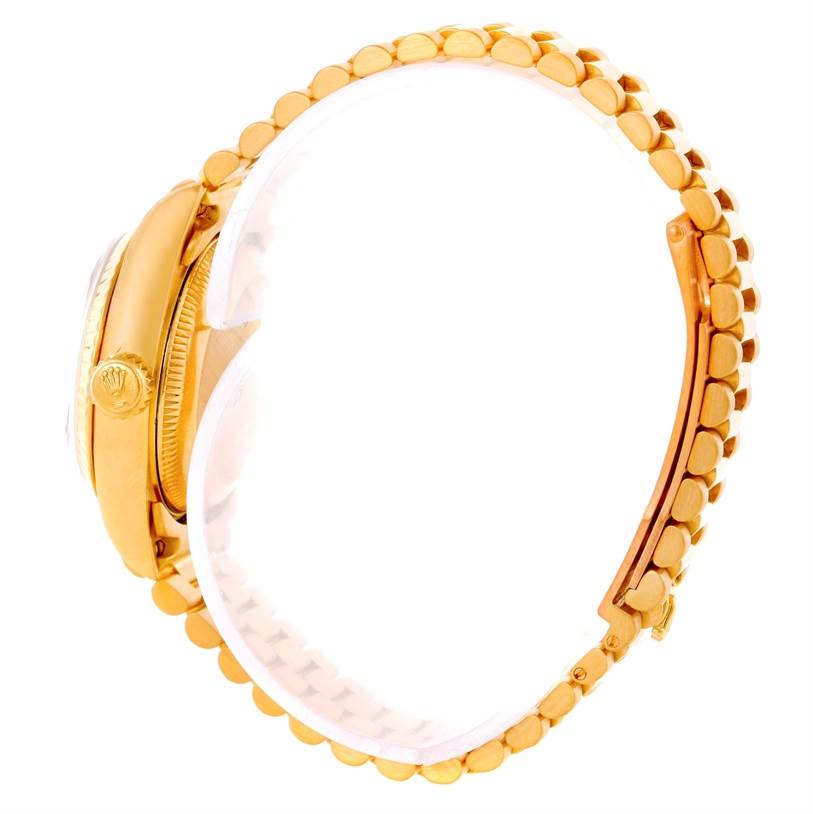 This image shows the side view of a Rolex President 69178 Women's Yellow Gold Black Dial 69178 Women's Yellow Gold Black Dial model watch, focusing on the crown and bracelet links.