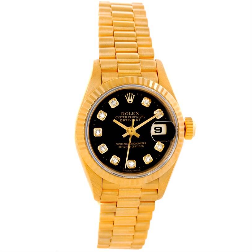 This image shows a Rolex President 69178 Women's Yellow Gold Black Dial 69178 Women's Yellow Gold Black Dial watch from a top-down angle, highlighting its gold bracelet, black dial, and date display.