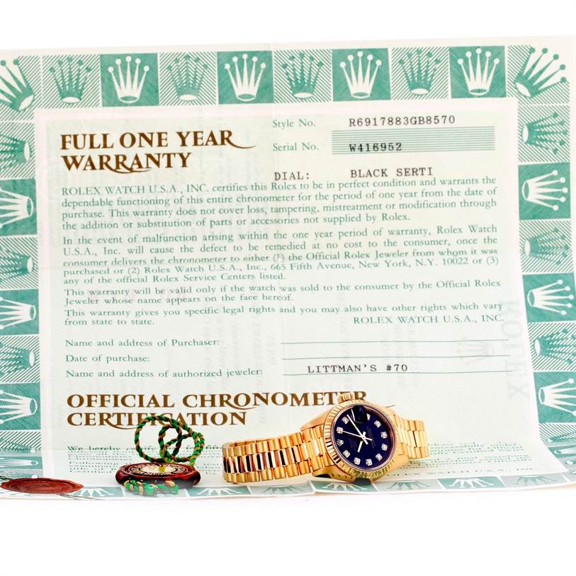 The image shows a Rolex President 69178 Women's Yellow Gold Black Dial 69178 Women's Yellow Gold Black Dial model watch placed on its official chronometer certification and warranty paperwork.