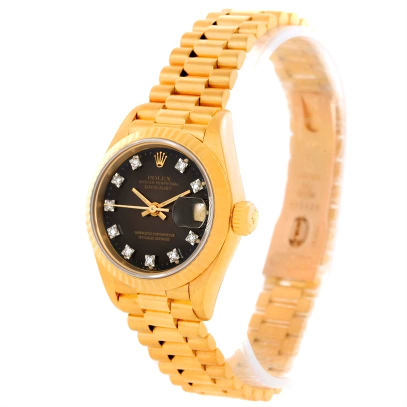 The image shows a Rolex President 69178 Women's Yellow Gold Brown Dial 69178 Women's Yellow Gold Brown Dial model watch from an angle showcasing the black dial, gold case, bracelet, and crown.