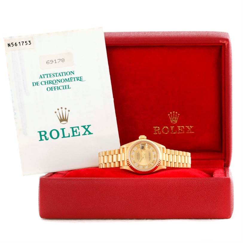 The image shows a Rolex President 69178 Women's Yellow Gold Champagne Dial 69178 Women's Yellow Gold Champagne Dial model watch in a red box with its official chronometer certification.