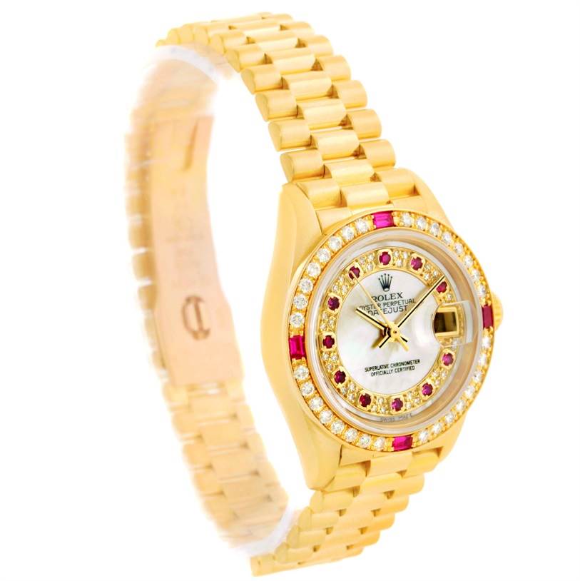 The image shows a Rolex President 79068 Women's Yellow Gold Mother of Pearl Dial 79068 Women's Yellow Gold Mother of Pearl Dial model at a slight angle, displaying its gold bracelet, jeweled bezel, and watch face.