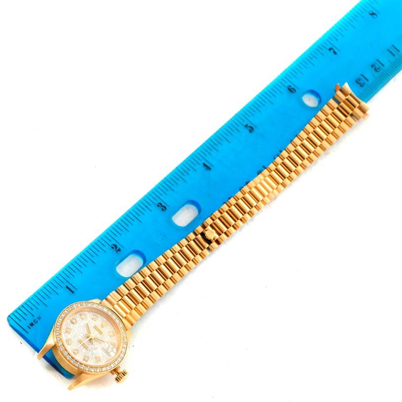 The image shows a Rolex President 69138 Women's Yellow Gold Beige Dial 69138 Women's Yellow Gold Beige Dial model watch placed next to a blue ruler for scale, displaying the face and bracelet.