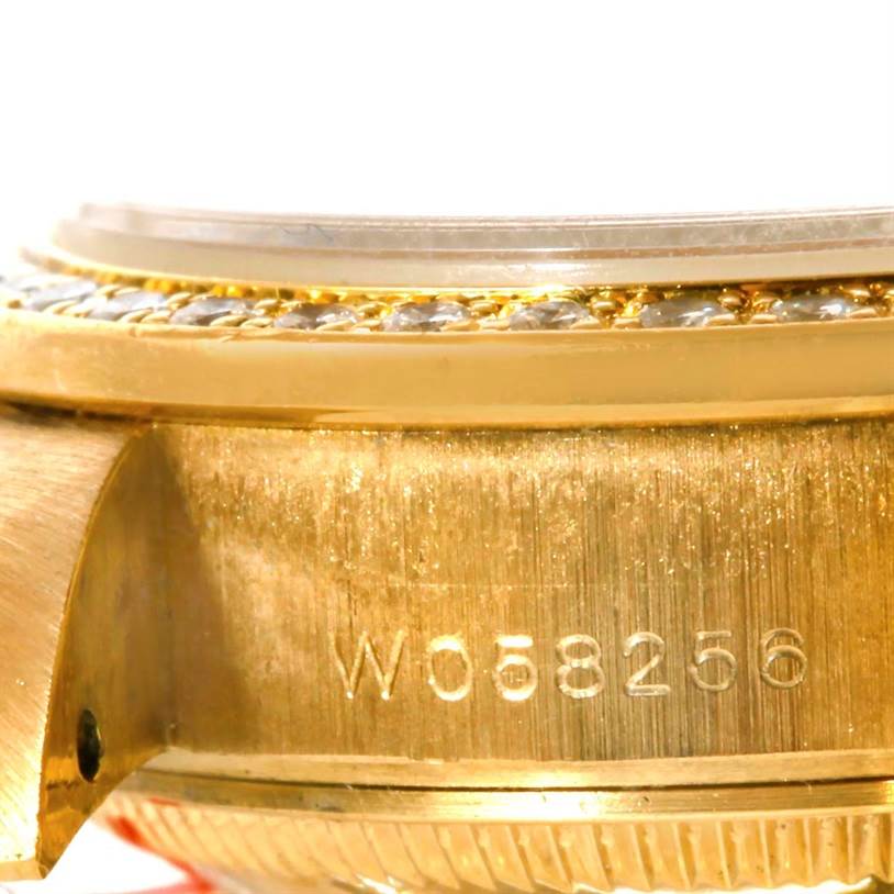 This close-up angle of a Rolex President 69138 Women's Yellow Gold Beige Dial 69138 Women's Yellow Gold Beige Dial watch shows the serial number engraved on the side of the gold case near the bezel.