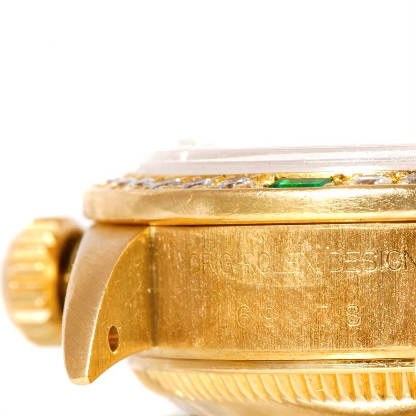 This close-up side view of the Rolex President 79068 Women's Yellow Gold Mother of Pearl Dial 79068 Women's Yellow Gold Mother of Pearl Dial model shows the crown and part of the case with engravings.
