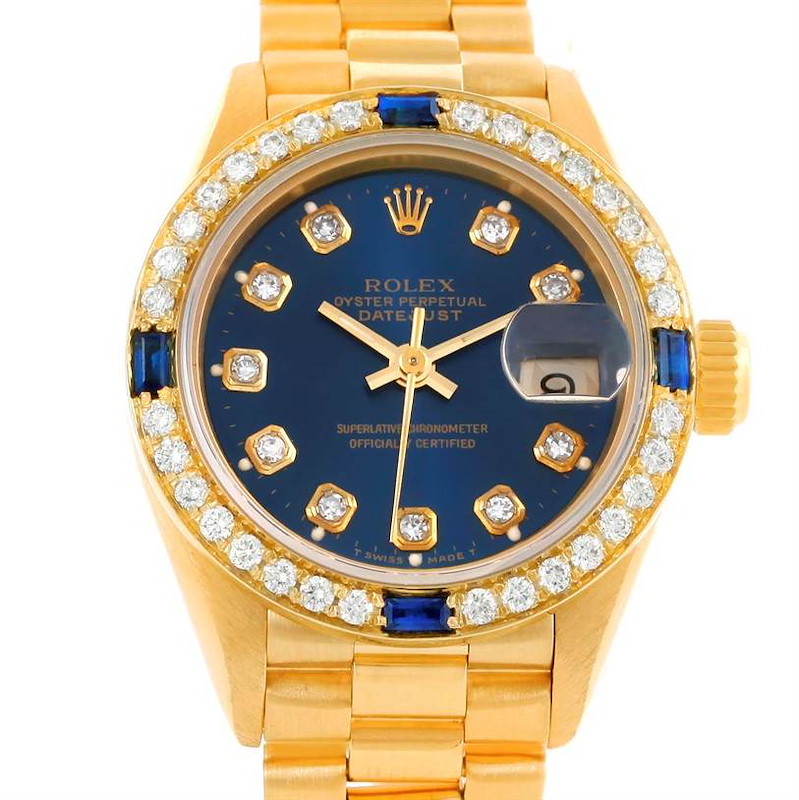 The image shows a frontal view of the Rolex President model watch with a gold band and a blue and diamond-studded dial bezel.