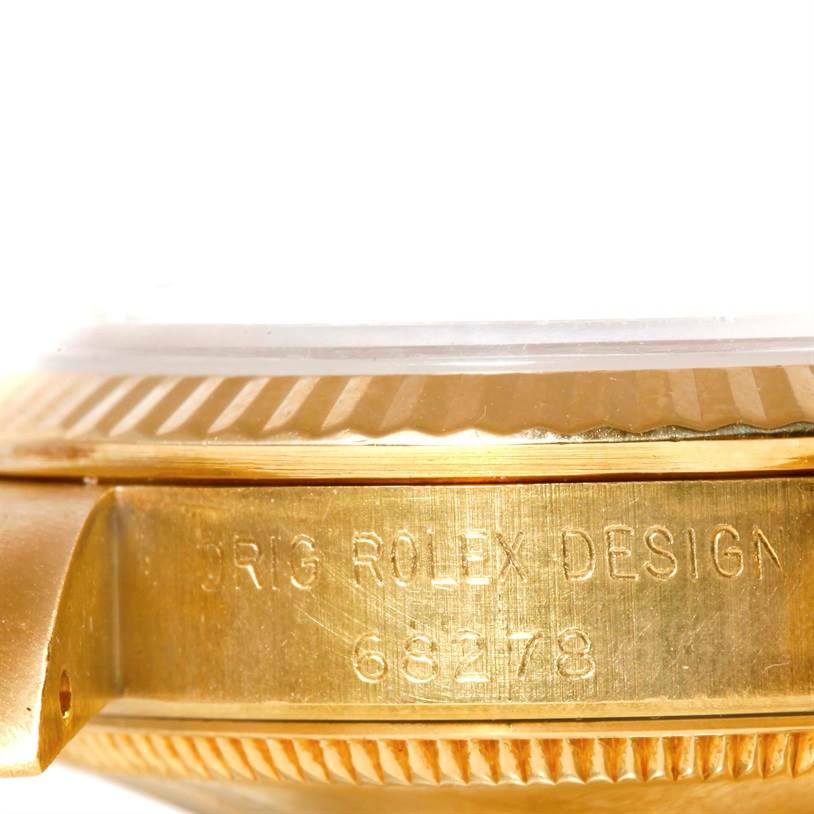 This close-up side view shows the case and lugs of a Rolex President 68278 Women's Yellow Gold Black Dial 68278 Women's Yellow Gold Black Dial model watch with its design number engraved.