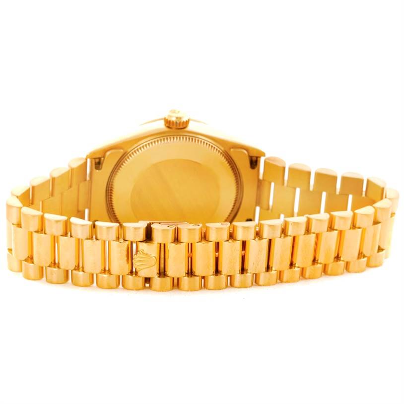 The image shows the backside of a Rolex President 68278 Women's Yellow Gold Black Dial 68278 Women's Yellow Gold Black Dial model watch, highlighting its case back and gold bracelet.