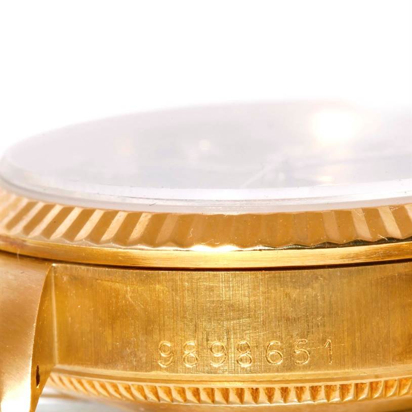 This image shows a close-up angle of the side bezel and case of a Rolex President 68278 Women's Yellow Gold Black Dial 68278 Women's Yellow Gold Black Dial watch, highlighting the engraved serial number.