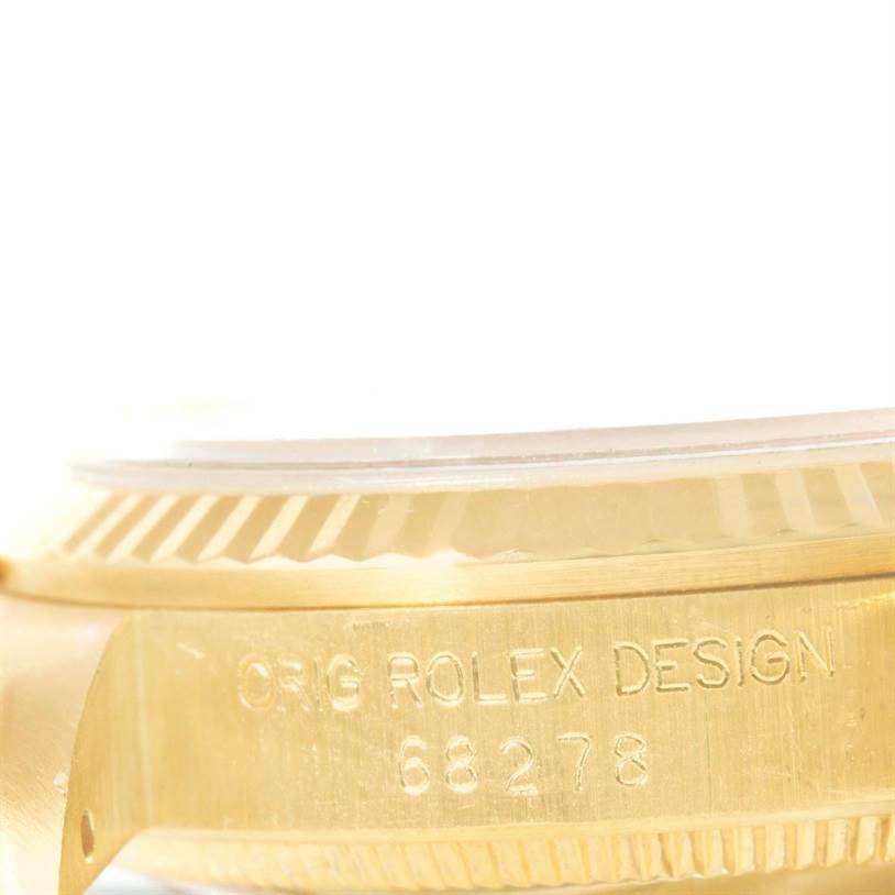 This image shows a close-up of the side of a Rolex President 68278 Women's Yellow Gold Beige Dial 68278 Women's Yellow Gold Beige Dial model, highlighting the engraved design and model number.