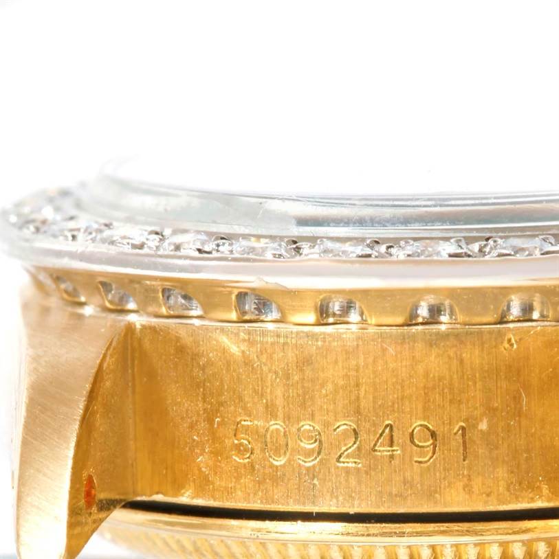 This close-up angle shows the serial number and diamond bezel of the Rolex President 6917 Women's Yellow Gold Green Dial 6917 Women's Yellow Gold Green Dial model.