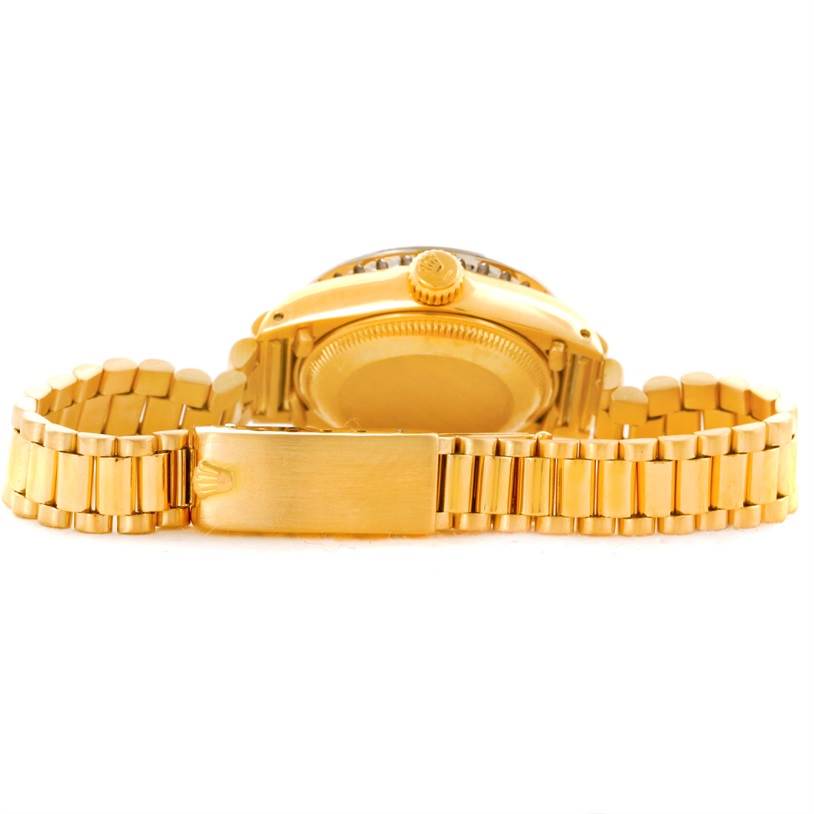 The image shows the back case and band of a gold Rolex President 6917 Women's Yellow Gold Green Dial 6917 Women's Yellow Gold Green Dial model watch from a side-bottom angle.