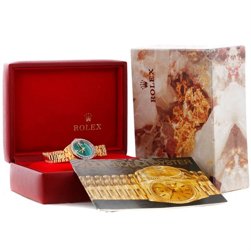 The image shows a Rolex President 6917 Women's Yellow Gold Green Dial 6917 Women's Yellow Gold Green Dial model watch in its opened box, accompanied by an outer box and a booklet.