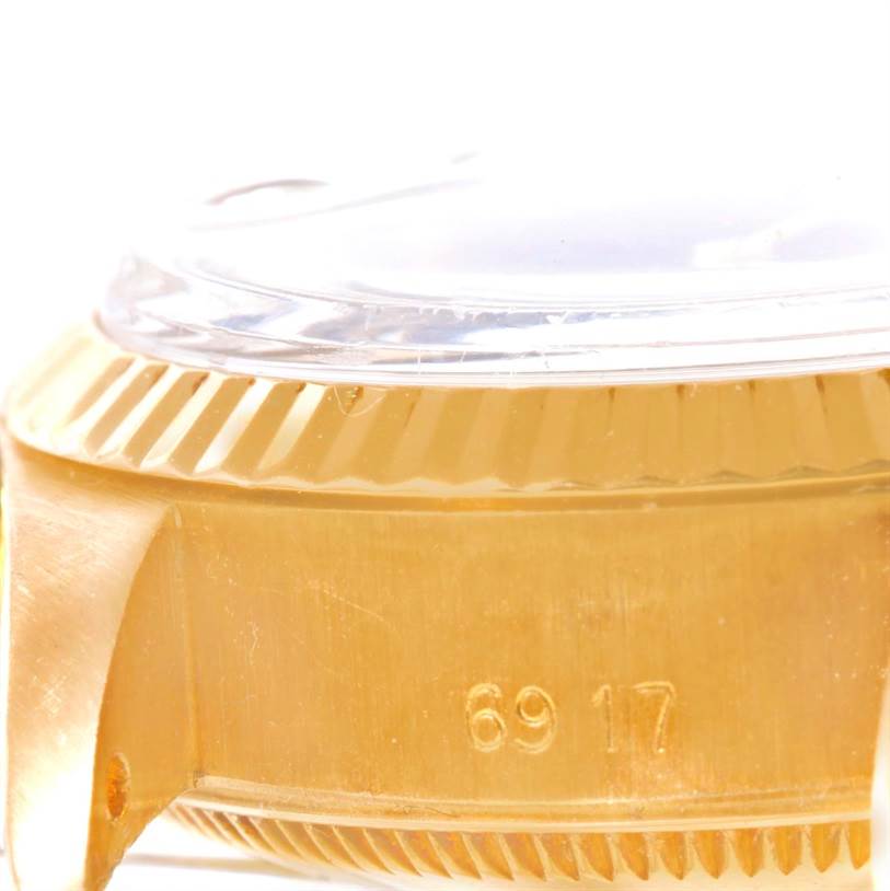 This image shows a close-up of the side of a Rolex President 6917 Women's Yellow Gold Blue Dial 6917 Women's Yellow Gold Blue Dial watch, highlighting the case and bezel with the model number.