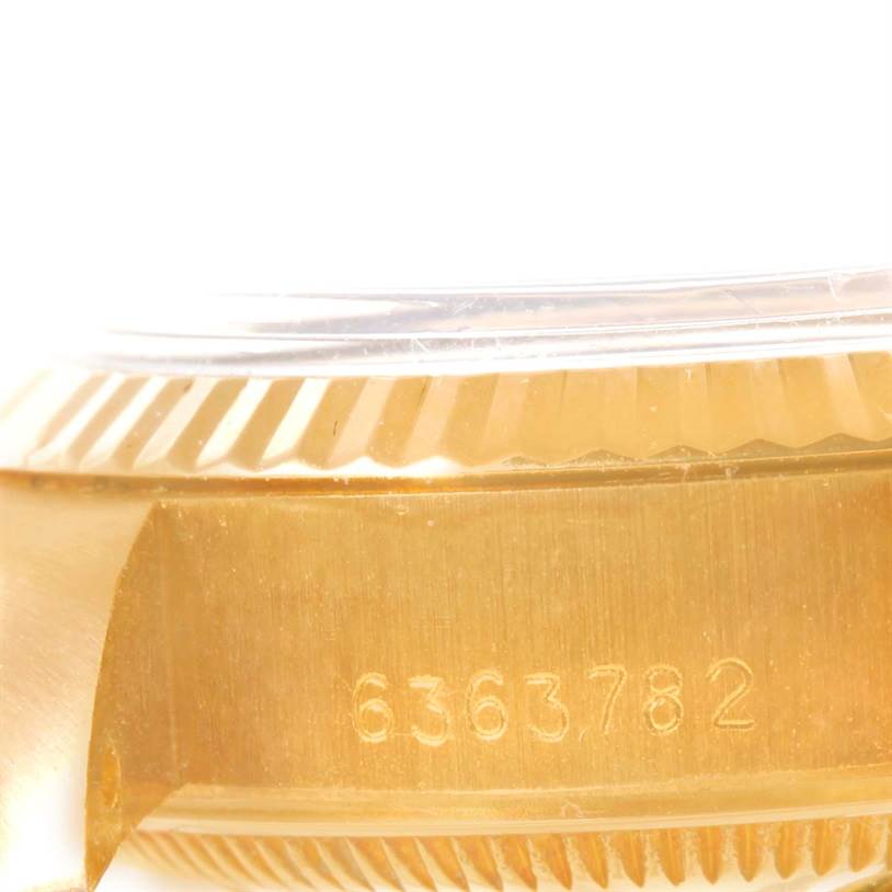 This image shows a close-up view of the side of a Rolex President 6917 Women's Yellow Gold Blue Dial 6917 Women's Yellow Gold Blue Dial watch, focusing on the serial number and part of the bezel.