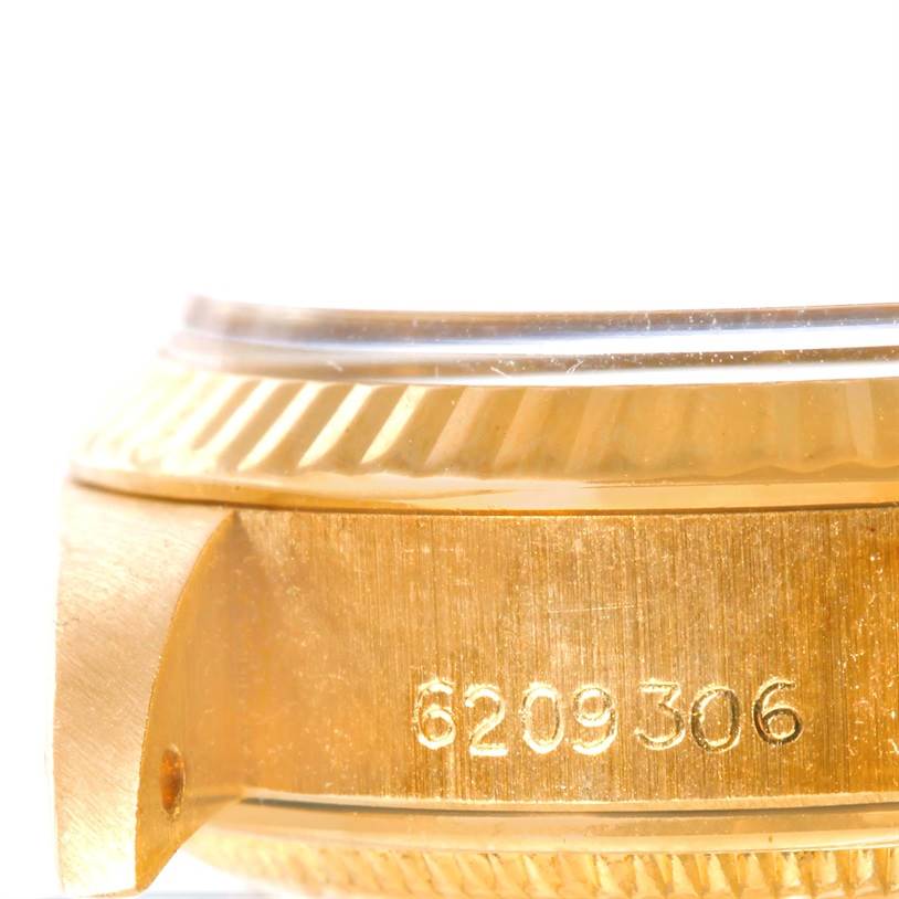 This image shows a side angle of the Rolex President 6917 Women's Yellow Gold Brown Dial 6917 Women's Yellow Gold Brown Dial watch case with its bezel and serial number visible.