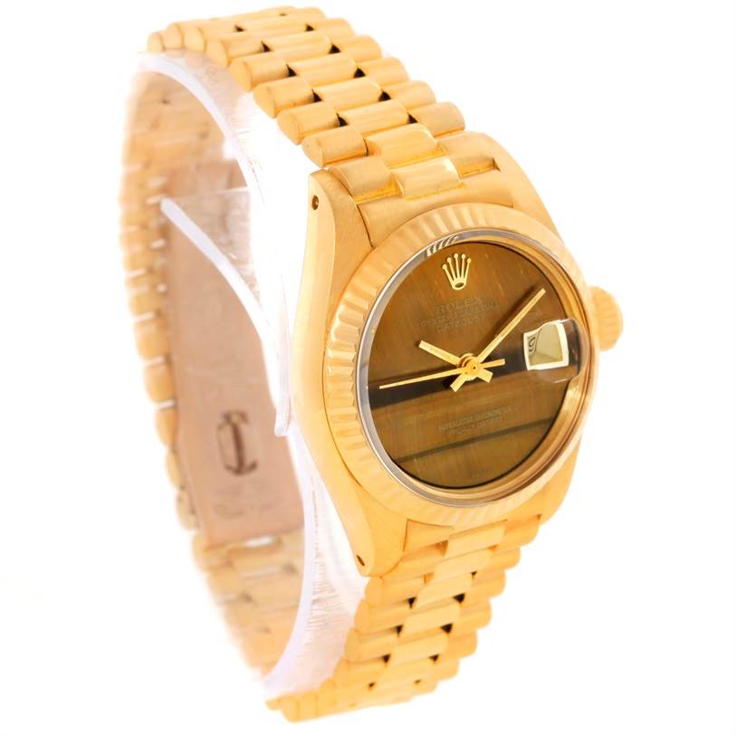The image shows a Rolex President 6917 Women's Yellow Gold Brown Dial 6917 Women's Yellow Gold Brown Dial model watch at an angle highlighting its face, bezel, crown, and bracelet.