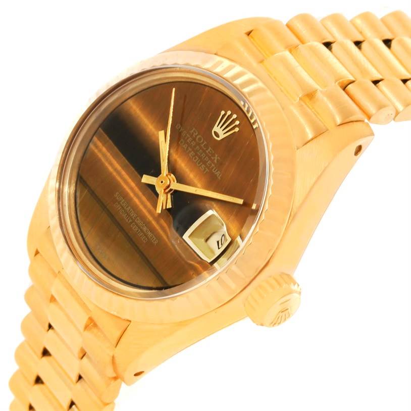 This is a side angle view of a Rolex President 6917 Women's Yellow Gold Brown Dial 6917 Women's Yellow Gold Brown Dial model watch showing the dial, date window, crown, and part of the bracelet.